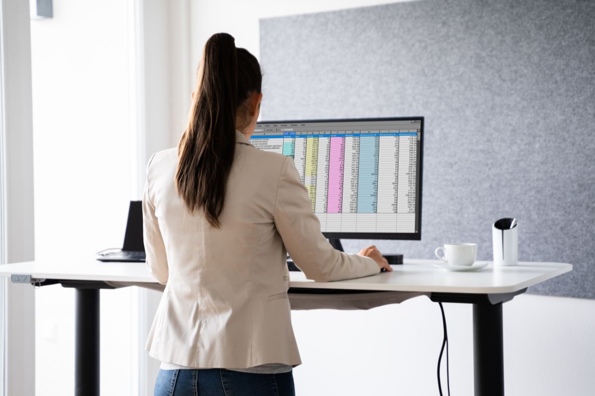 a woman using a standing desk working