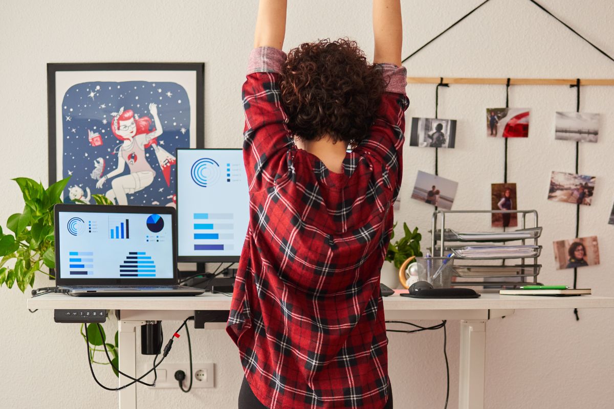 a woman using a standing desk