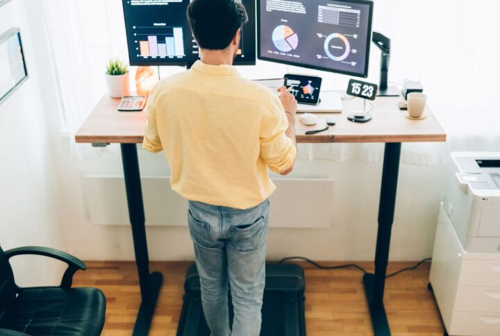 man using a standing desk for work