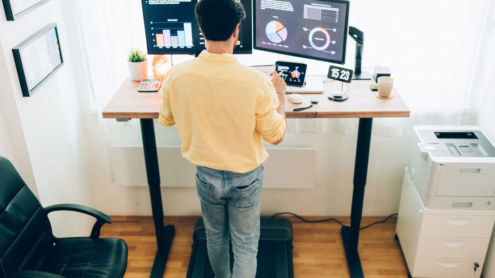 man using a standing desk for work 