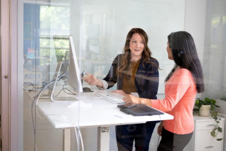 women in front of standing desk