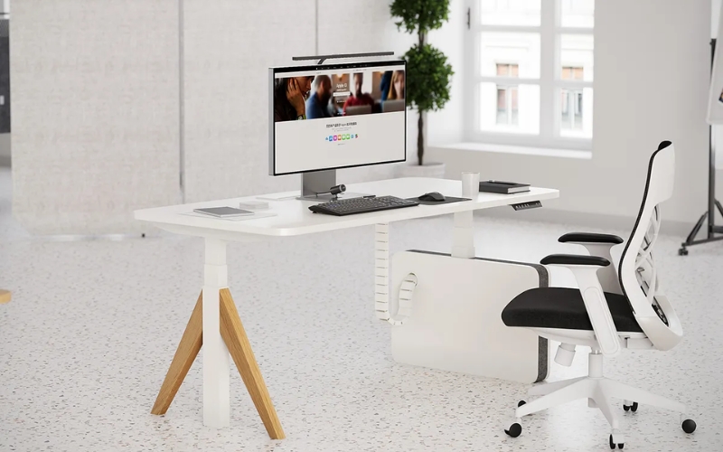 person using a height-adjustable desk under $500 at home